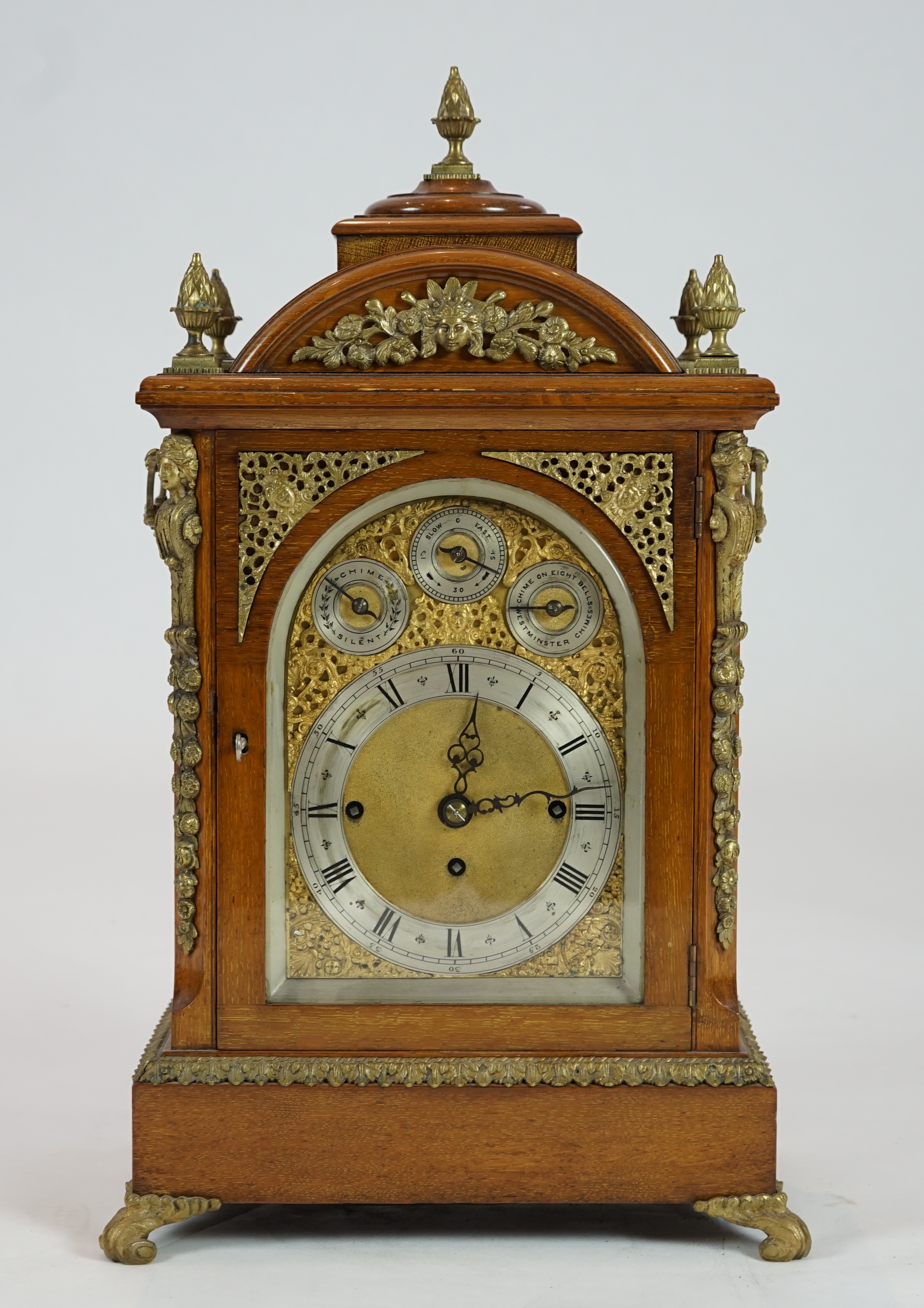 A late Victorian ormolu mounted golden oak cased eight day chiming bracket clock and bracket